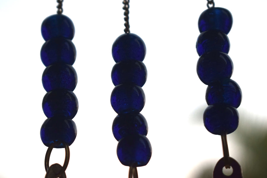 A detail of royal blue beads for a metal wind chime