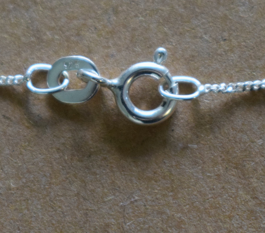 A close up of 925 sterling silver necklace clasp