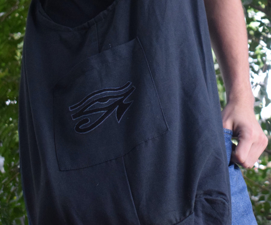 A black shoulder bag with the Eye of Horus embroidered on the front pocket