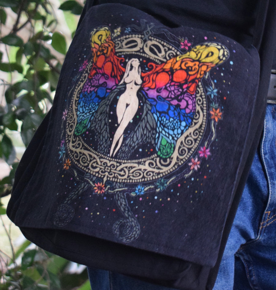 Rainbow angel, fairy, goddess printed on black bag worn on person wearing blue jeans