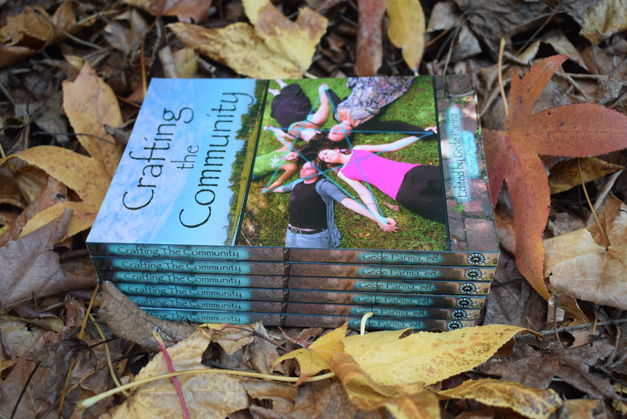 Six books titled Crafting the Community Edited by Gede Parma resting on a bed of leaves