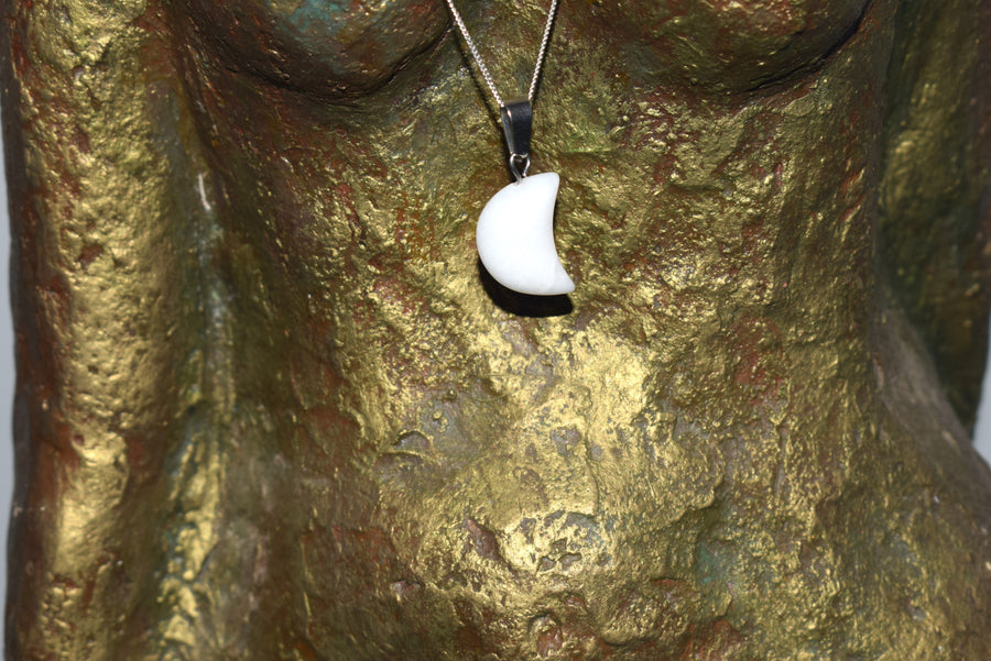 White quartz crescent moon pendant on sterling silver chain hung on goddess sculpture torso